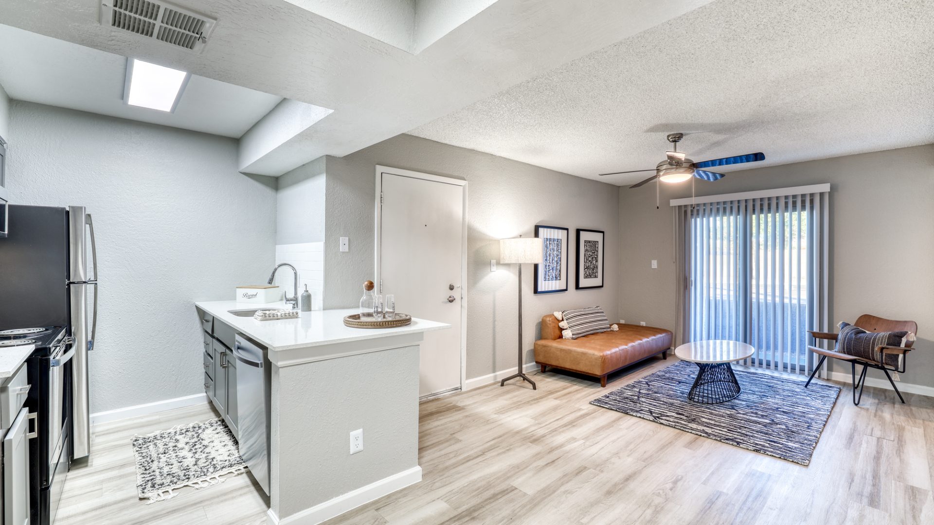 the living room and kitchen area of a two bedroom apartment at The Senara